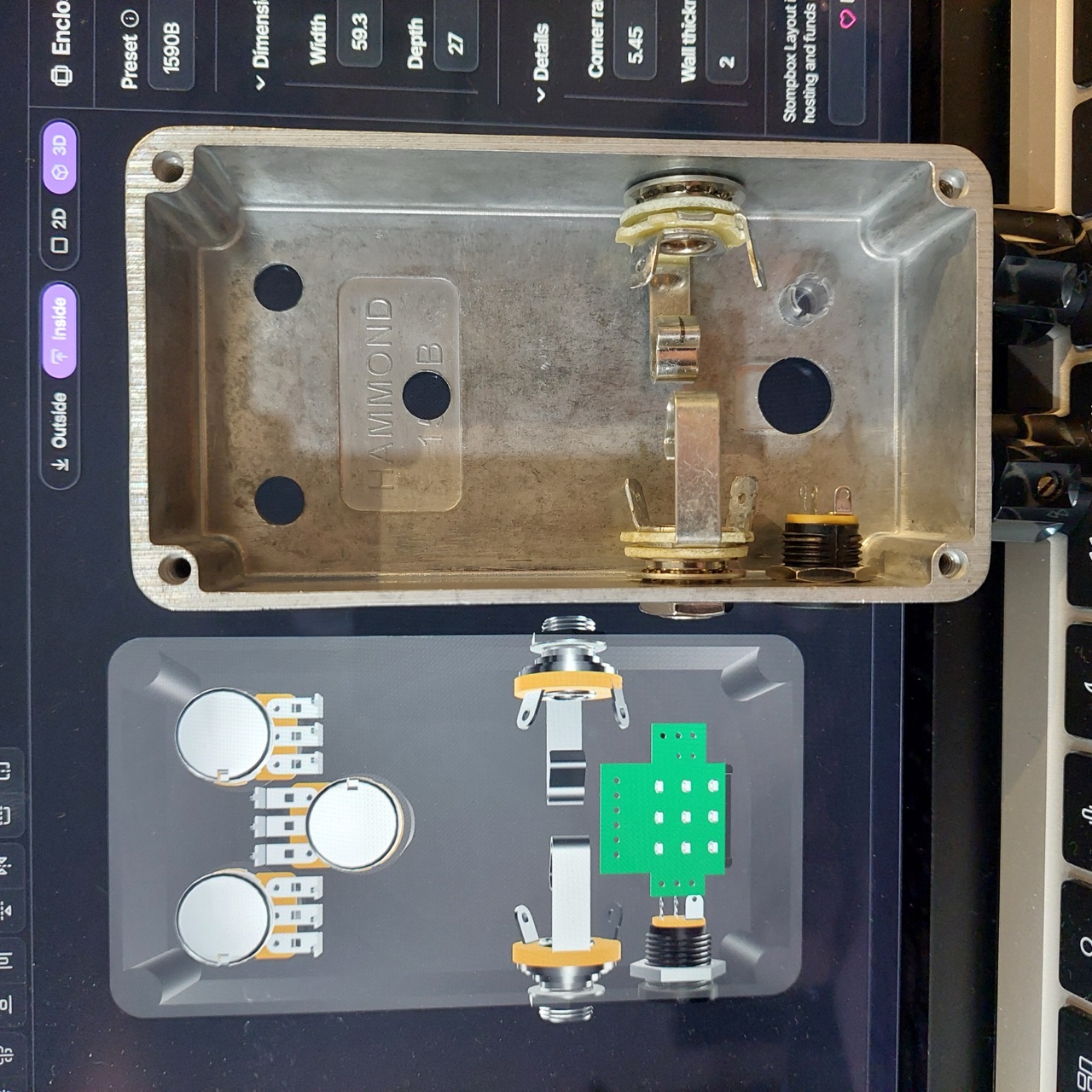 The inside view of a layout in the Stompbox Layout editor, beside the drilled 1590B it was made for, with its jacks and DC socket fitted.